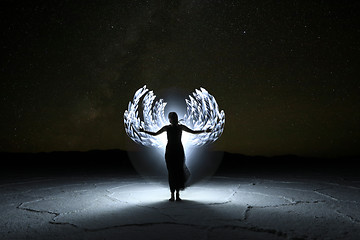 Image showing Light Painted Long Exposure Image of a Woman with the Milky Way