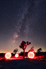 Image showing Bright Milky Way Core With Light Painted Orbs in the Landscape