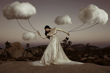 Image showing Abstract Concept of Girl Attached to Clouds Representing Fantasy