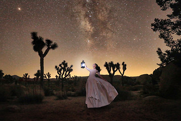 Image showing Girl Holding Lantern in the Desert Under the Milky Way