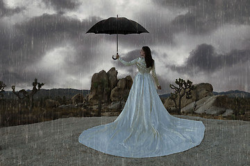 Image showing Abstract Concept of Girl Surrounded In Desert Raining