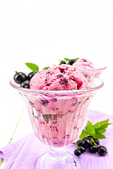 Image showing Ice cream with black currant in two glasses on board