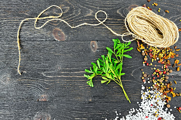 Image showing Rue leaves with twine on black board