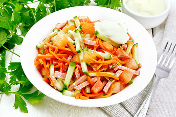 Image showing Salad of sausage and spicy carrots on board