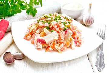 Image showing Salad of surimi and tomatoes with mayonnaise on table