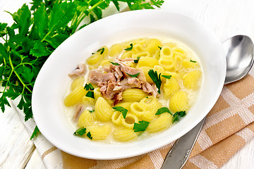 Image showing Soup creamy of chicken and pasta in plate on kitchen towel