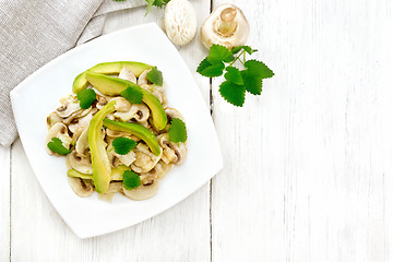Image showing Salad of avocado and champignons on board top