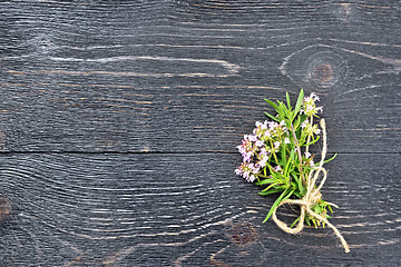 Image showing Thyme leaves and flowers on black board