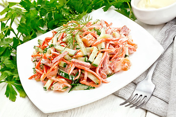 Image showing Salad of sausage and spicy carrots with mayonnaise on wooden boa