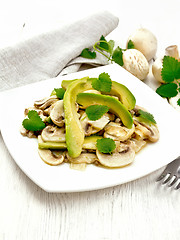 Image showing Salad of avocado and champignons on wooden board