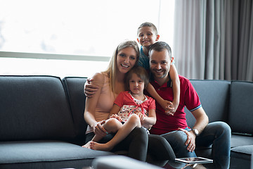 Image showing happy young couple spending time with kids