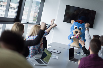 Image showing boss dresed as bear having fun with business people in trendy of