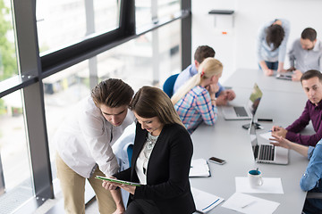 Image showing Two Business People Working With Tablet in office