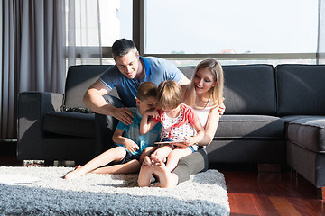 Image showing happy young couple spending time with kids