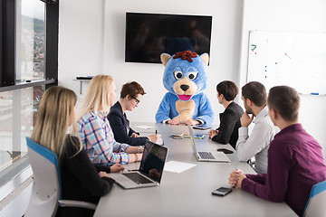 Image showing boss dresed as bear having fun with business people in trendy of