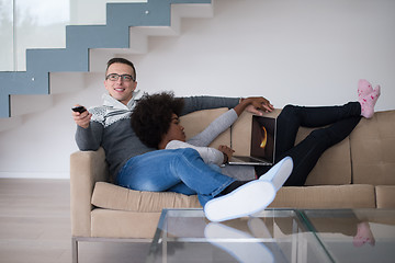 Image showing multiethnic couple relaxing at home