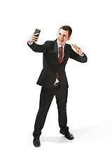 Image showing Happy businessman talking on the phone isolated over white background in studio shooting