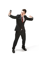 Image showing Happy businessman talking on the phone isolated over white background in studio shooting