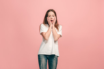 Image showing Beautiful teen girl looking suprised isolated on pink