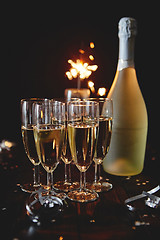 Image showing Party composition image. Glasses filled with champagne placed on black table