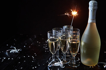 Image showing Party composition image. Glasses filled with champagne placed on black table