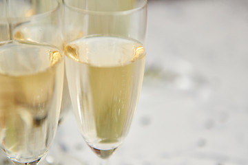 Image showing Champagne glasses and bottle placed on white marble background