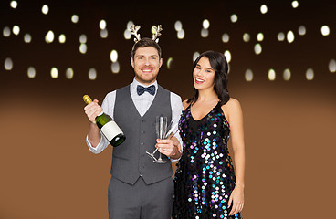 Image showing couple with champagne bottle at christmas party