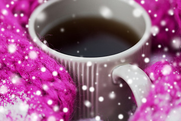 Image showing close up of tea or coffee and winter scarf in snow