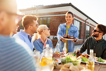 Image showing friends at barbecue party on rooftop in summer