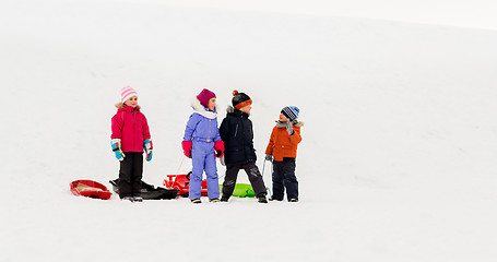 Image showing happy little kids with sleds in winter