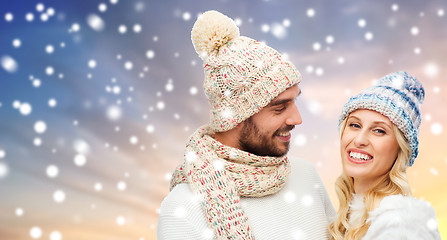 Image showing happy couple in winter clothes over snow