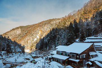 Image showing country houses and forest hills in winter, japan