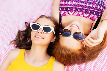 Image showing teenage girls in sunglasses on picnic blanket