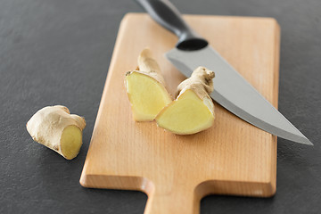 Image showing close up of ginger root and knife on cutting board