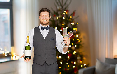 Image showing man with bottle of champagne and glasses at party