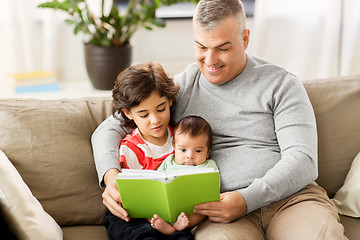 Image showing happy father with sons reading book at home