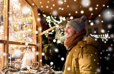 Image showing happy man looking at christmas market shop window