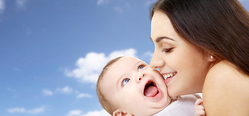 Image showing mother with baby over sky background