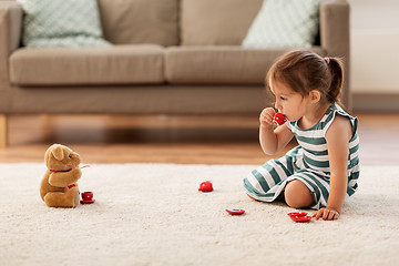 Image showing little girl playing with toy tea set at home