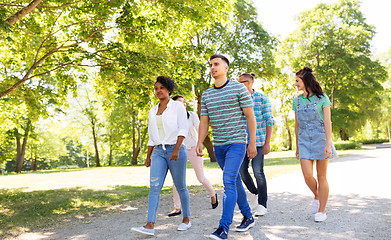 Image showing happy international friends walking in park