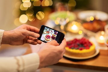 Image showing hands photographing food at christmas dinner