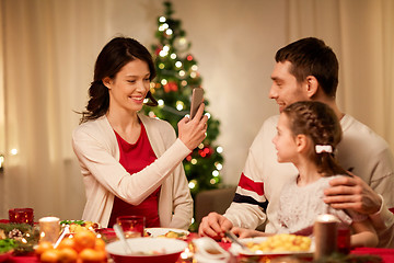 Image showing happy family taking picture at christmas dinner