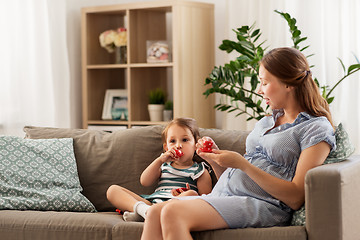 Image showing pregnant mother and daughter playing tea party