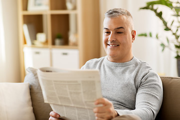 Image showing man reading newspaper at home