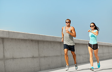 Image showing couple in sports clothes running outdoors