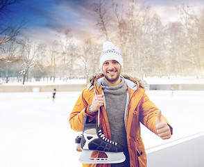 Image showing happy young man showing thumbs up on skating rink