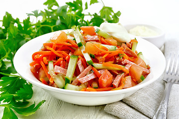 Image showing Salad of sausage and spicy carrots on light board