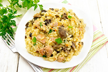 Image showing Risotto with mushrooms and chicken on board