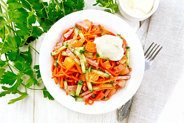 Image showing Salad of sausage and spicy carrots on board top