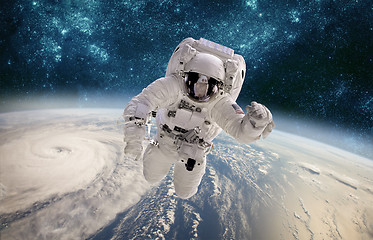 Image showing Astronaut in outer space against the backdrop of the planet eart